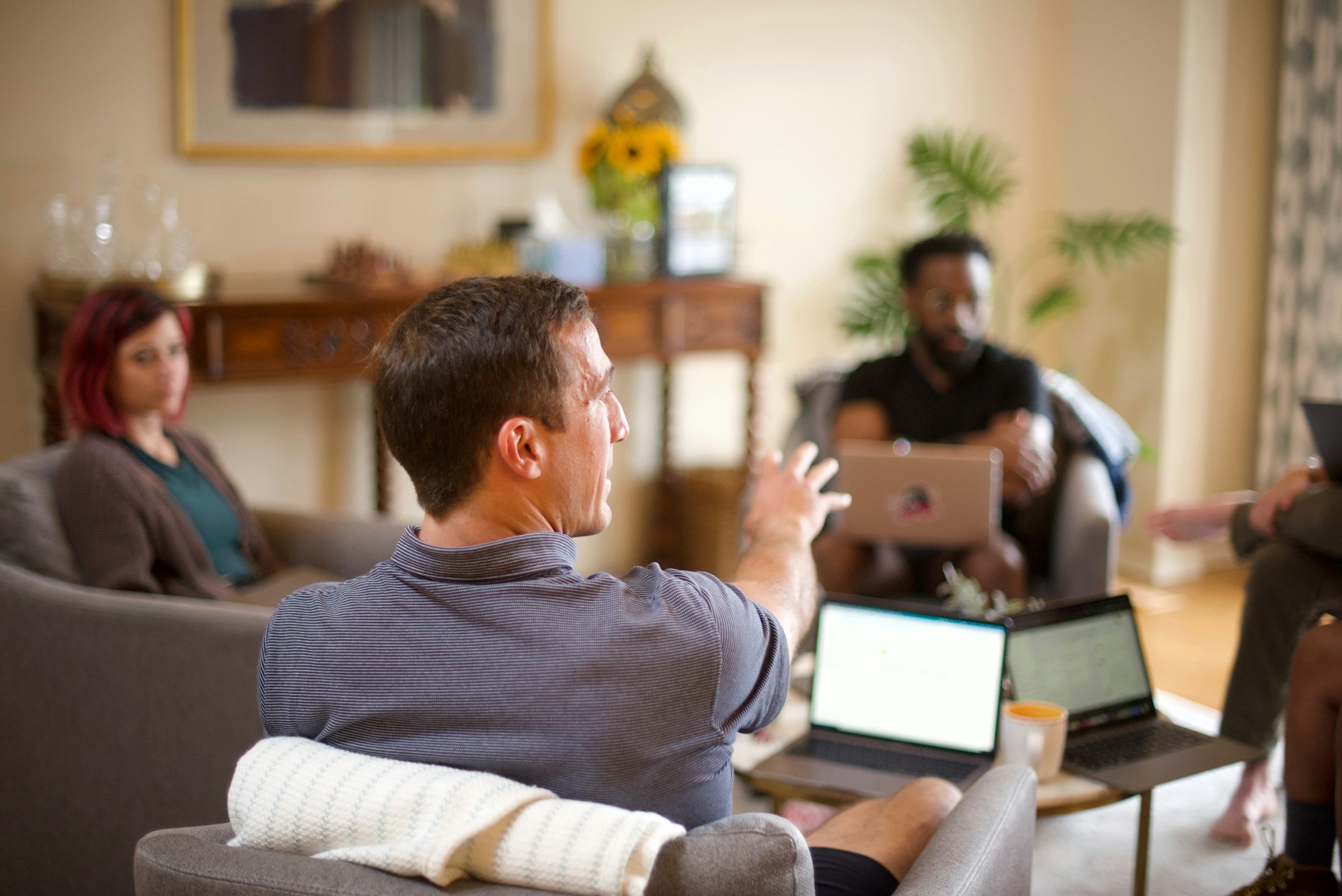 a group of people sitting in a meeting 